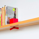 Illustration for article titled Clamp Shelf Tightens So Your Books Never Fall Again